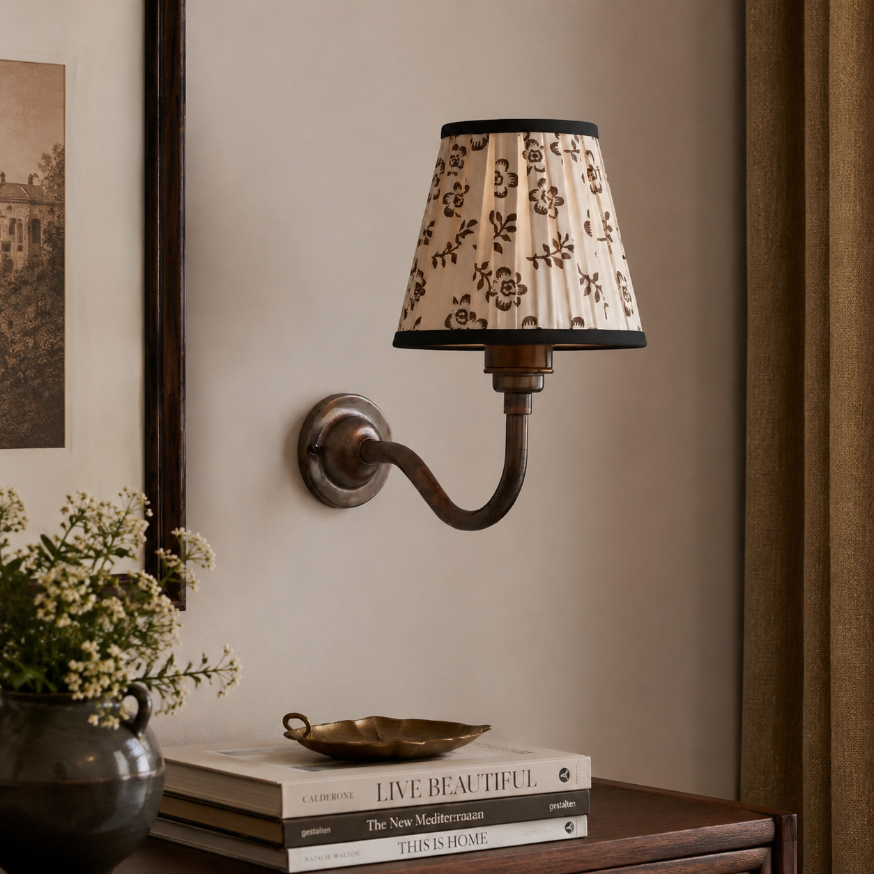 Cottaloy curved-arm wall lamp styled in a warm room