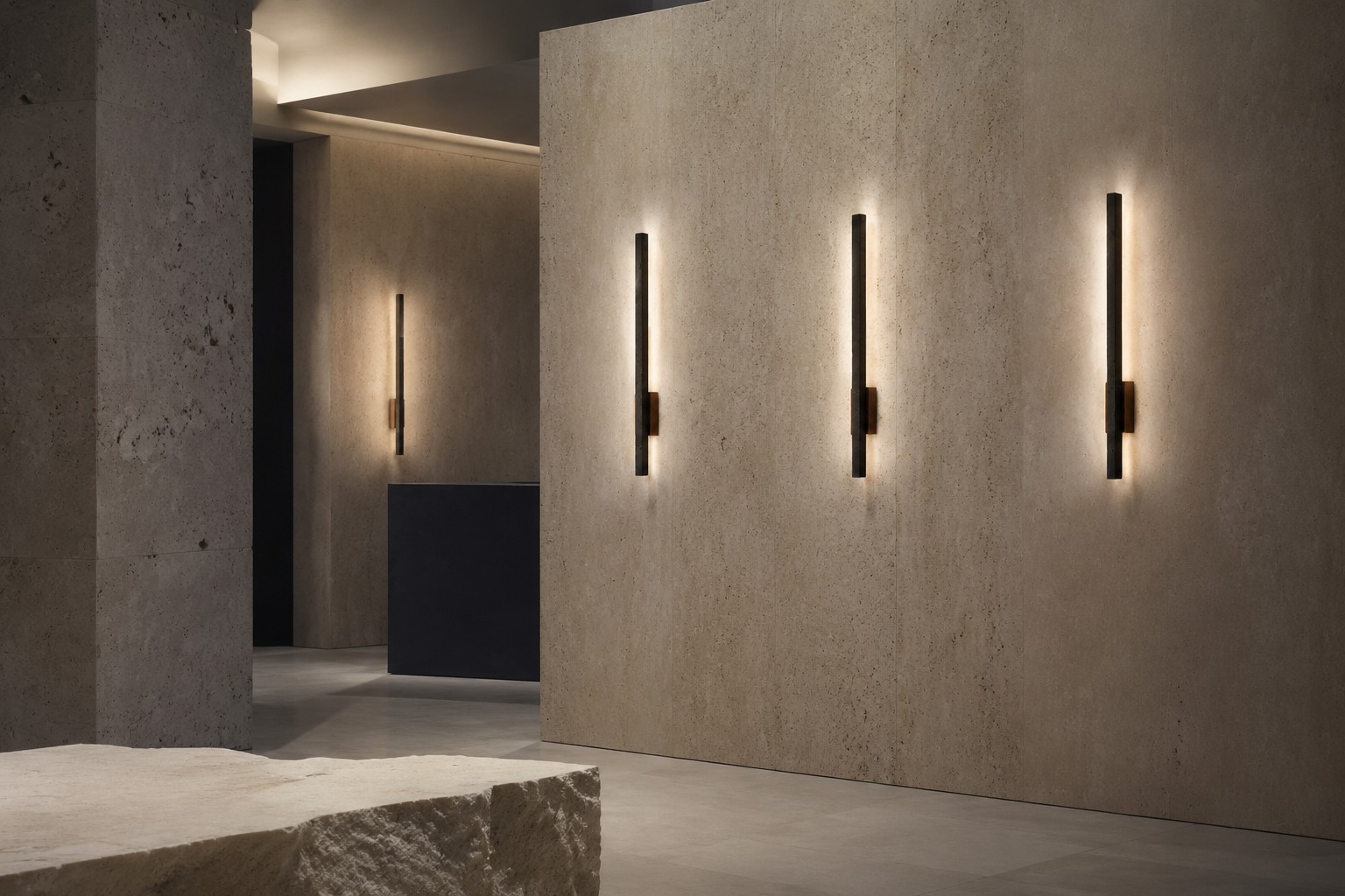 Linear travertine and wood LED wall lights casting a warm glow