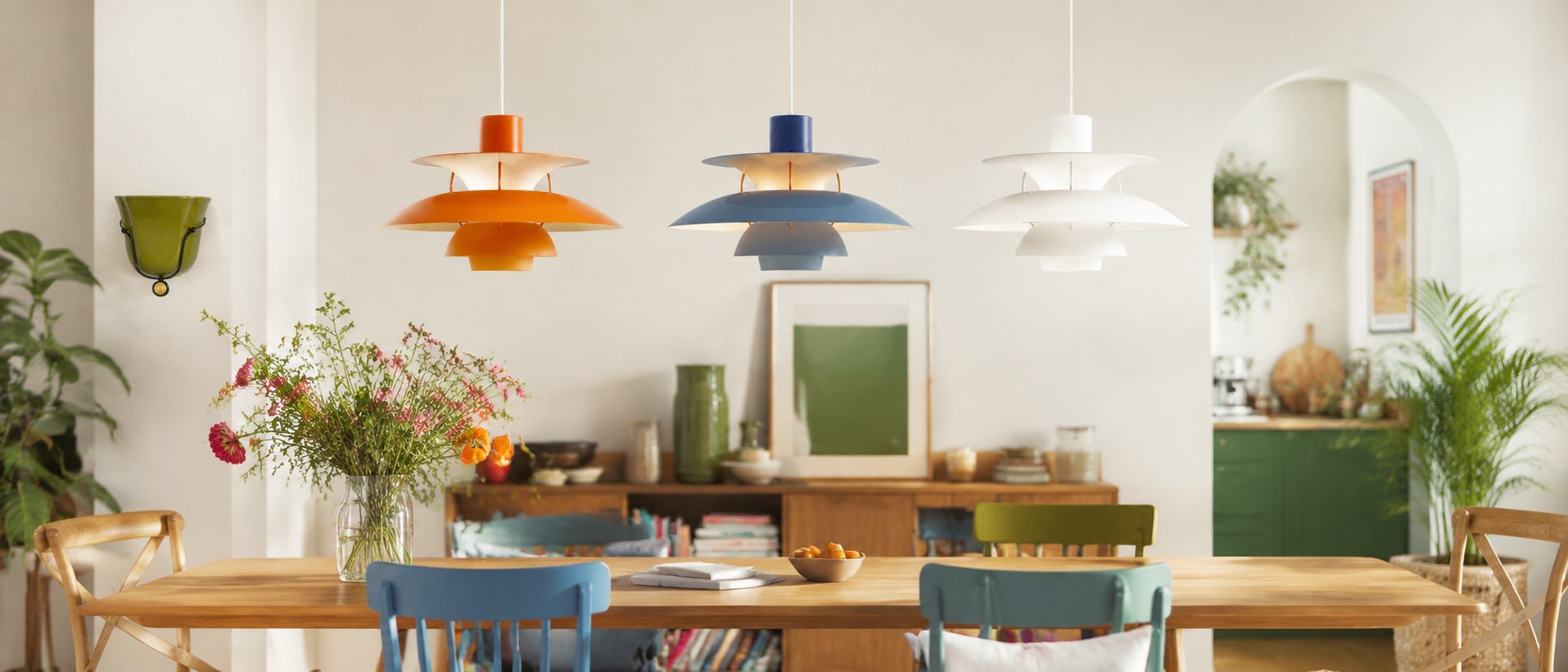 Colorful designer pendant lights above a dining table