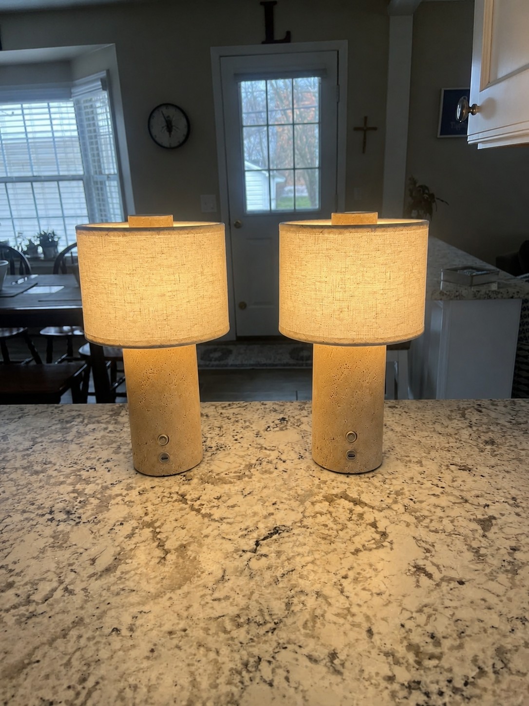Two rechargeable travertine table lamps switched on in a customer kitchen