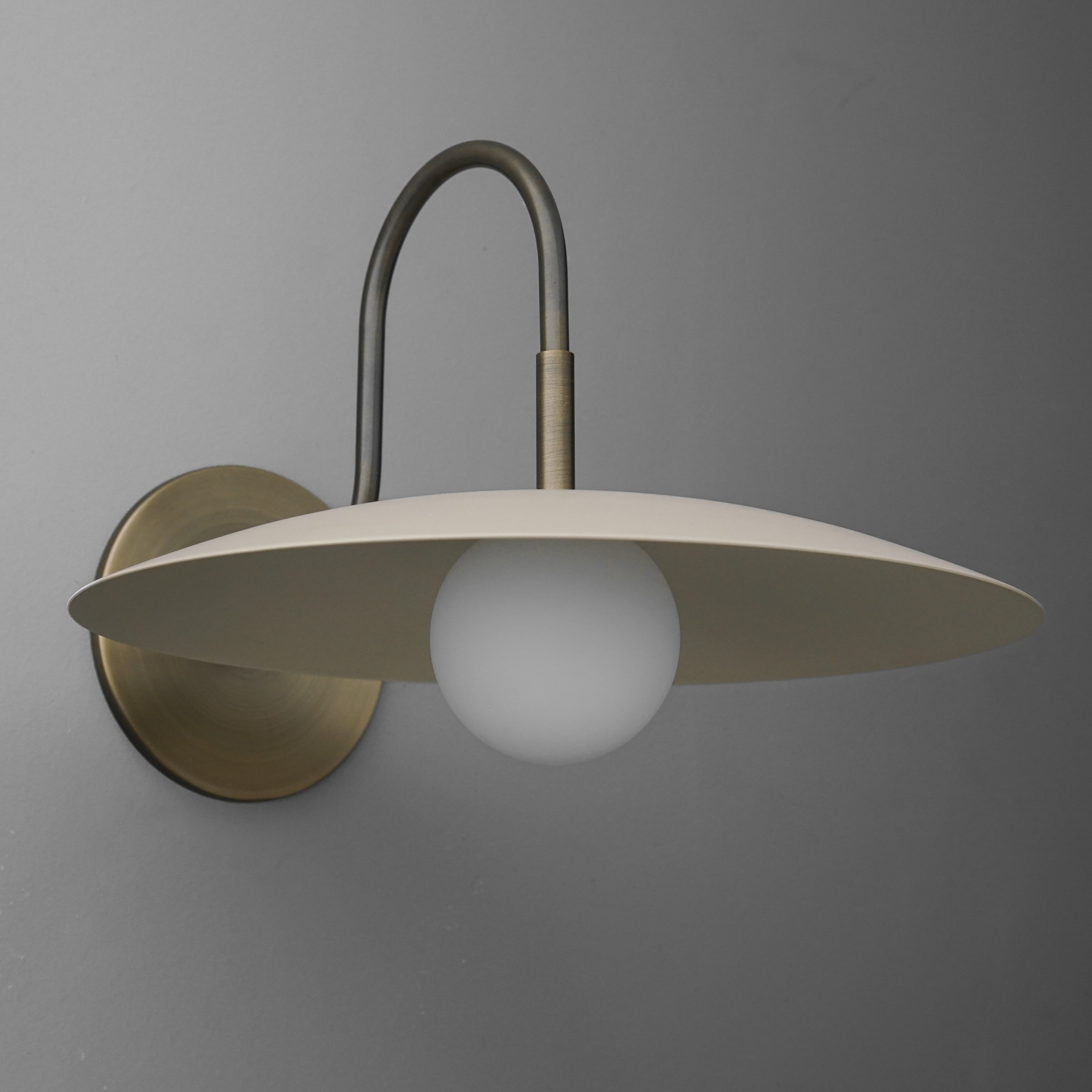 Curva Metal Modern Wall Sconce - Antique Brass Arm with Cream Disc Shade K1540