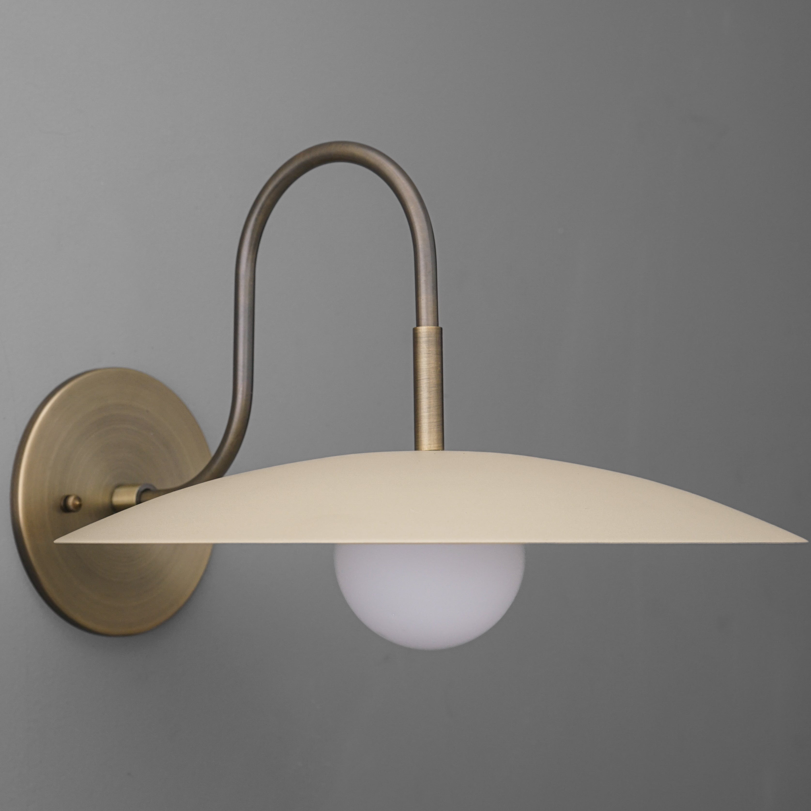 Curva Metal Modern Wall Sconce - Antique Brass Arm with Cream Disc Shade K1540