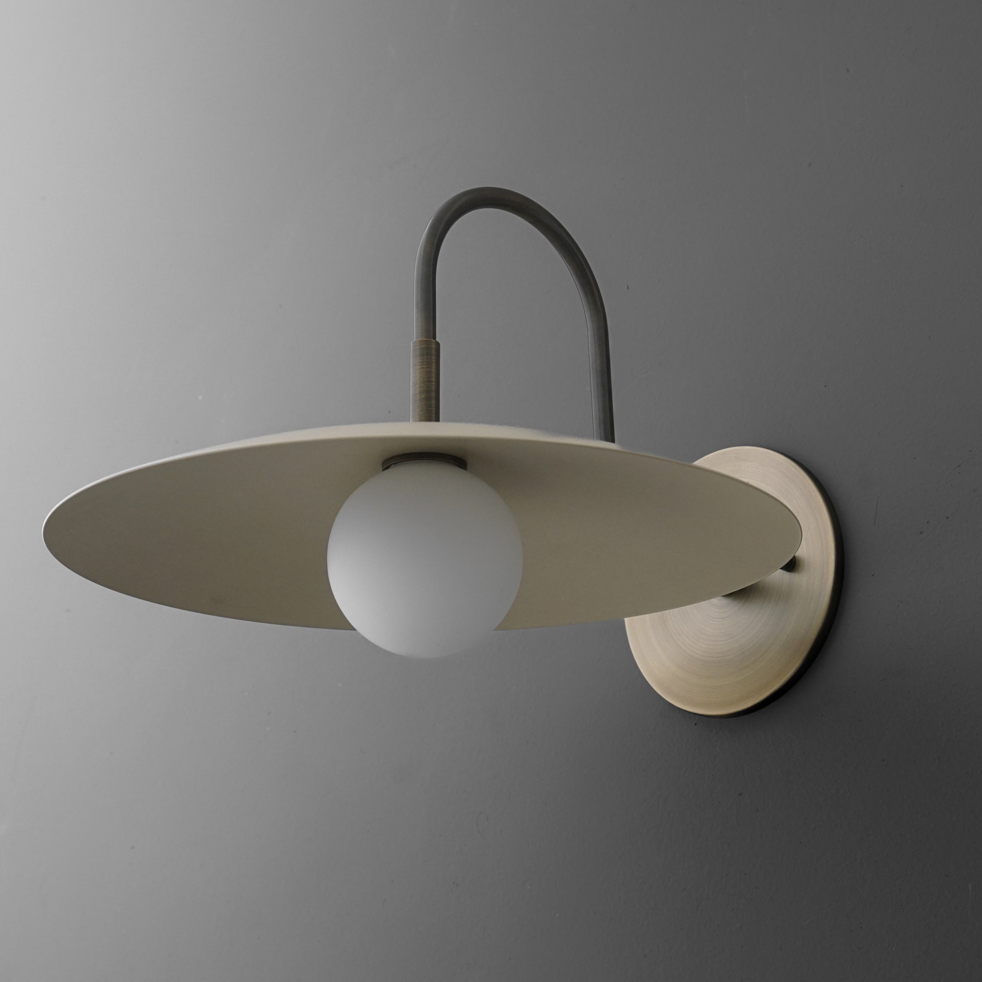 Curva Metal Modern Wall Sconce - Antique Brass Arm with Cream Disc Shade K1540