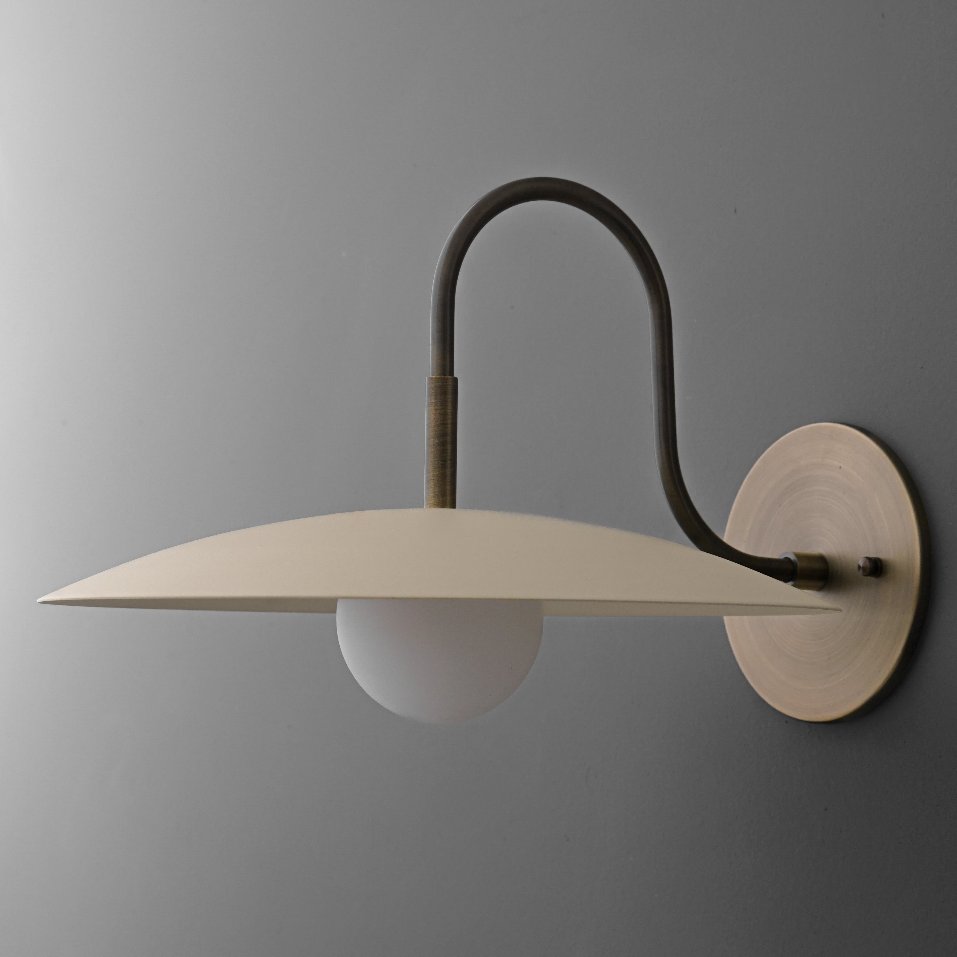 Curva Metal Modern Wall Sconce - Antique Brass Arm with Cream Disc Shade K1540