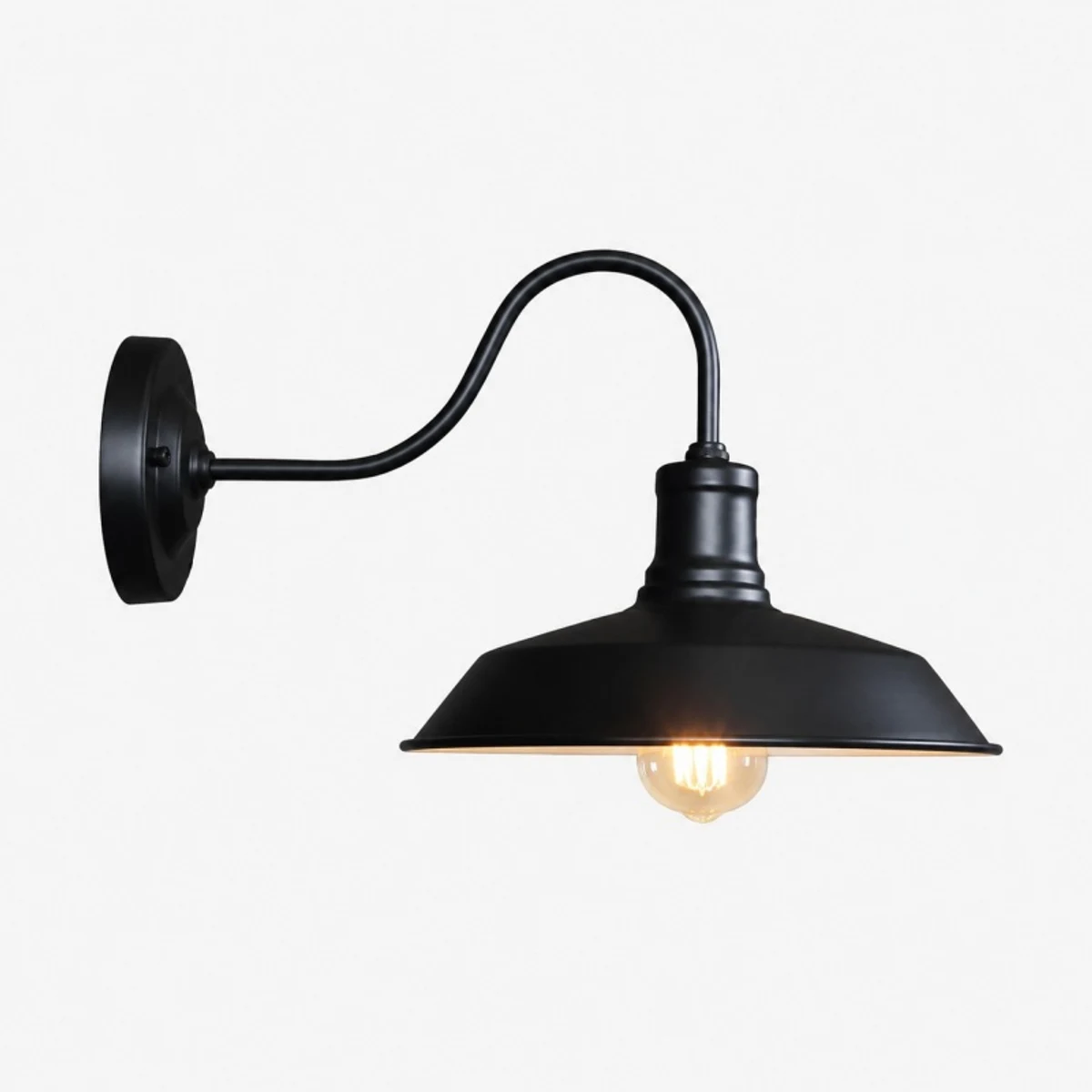 Black wall sconce with warm light on white background