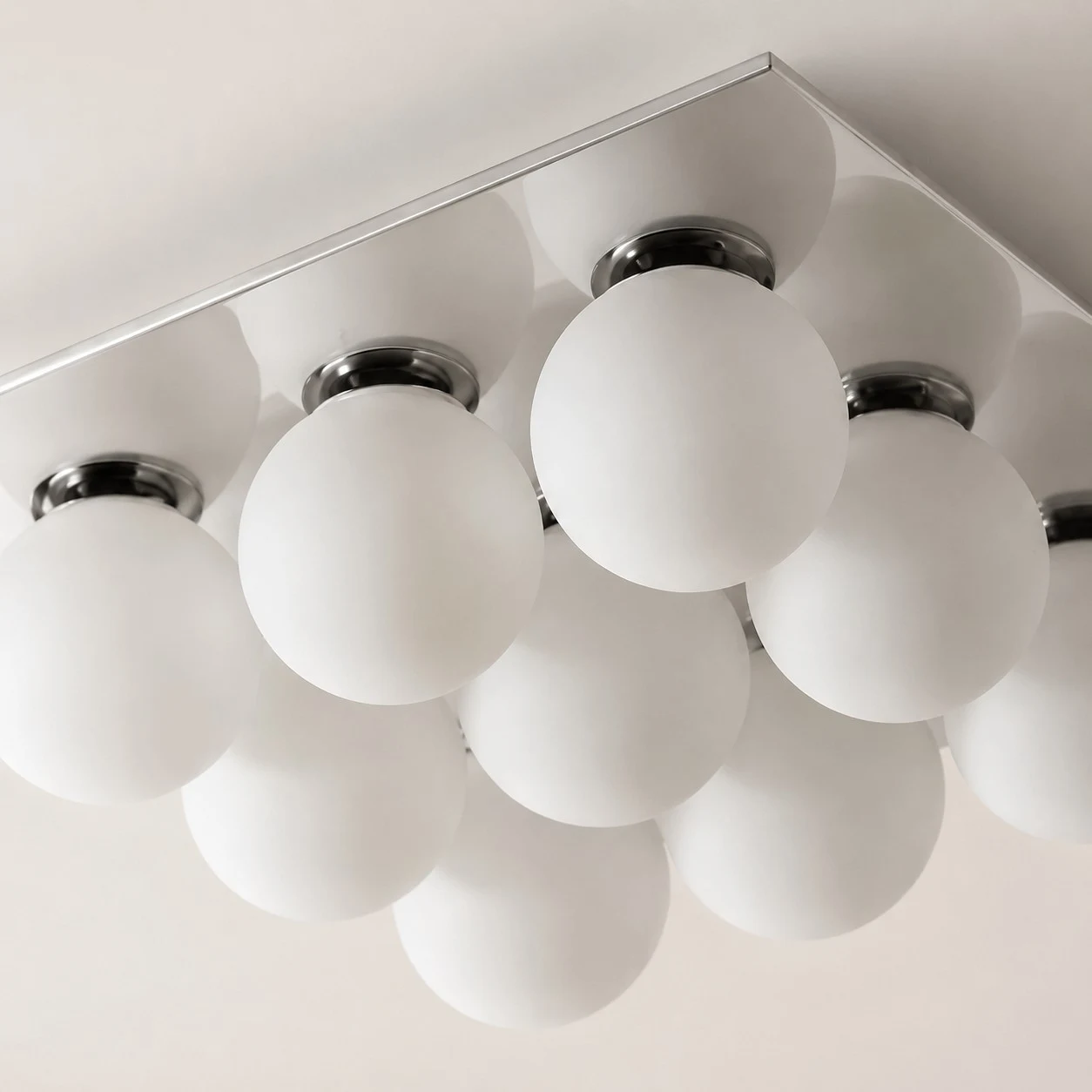 Detail image: frosted glass globes and chrome lamp holders.