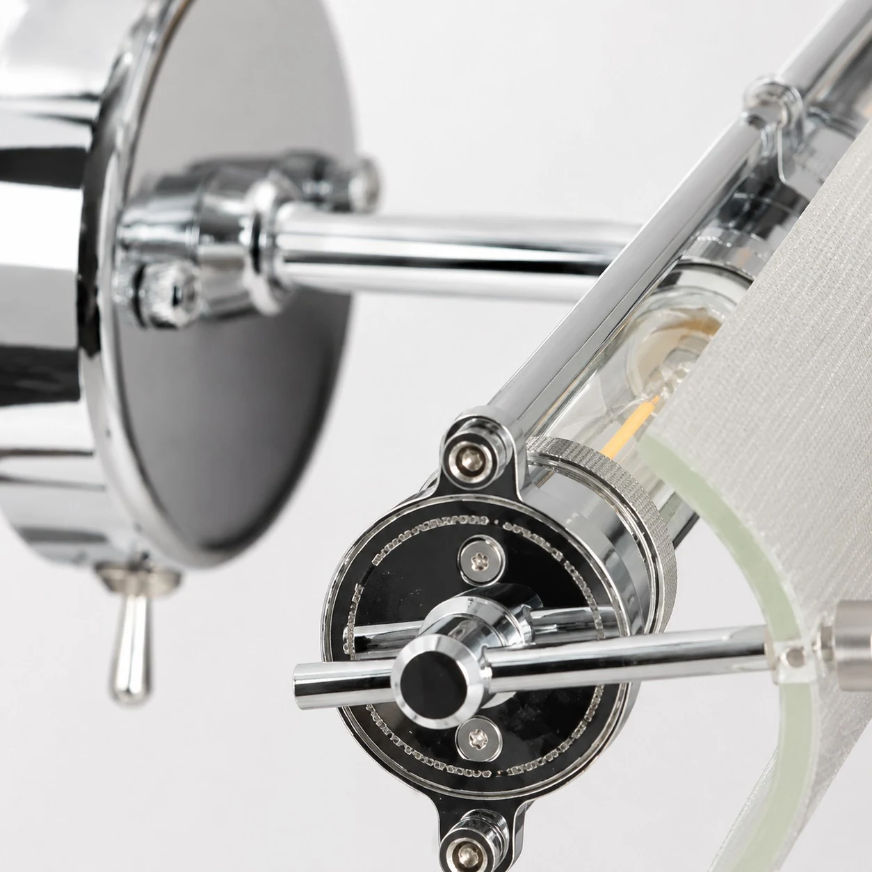 Adjustable joint and chrome hardware detail on the wall light