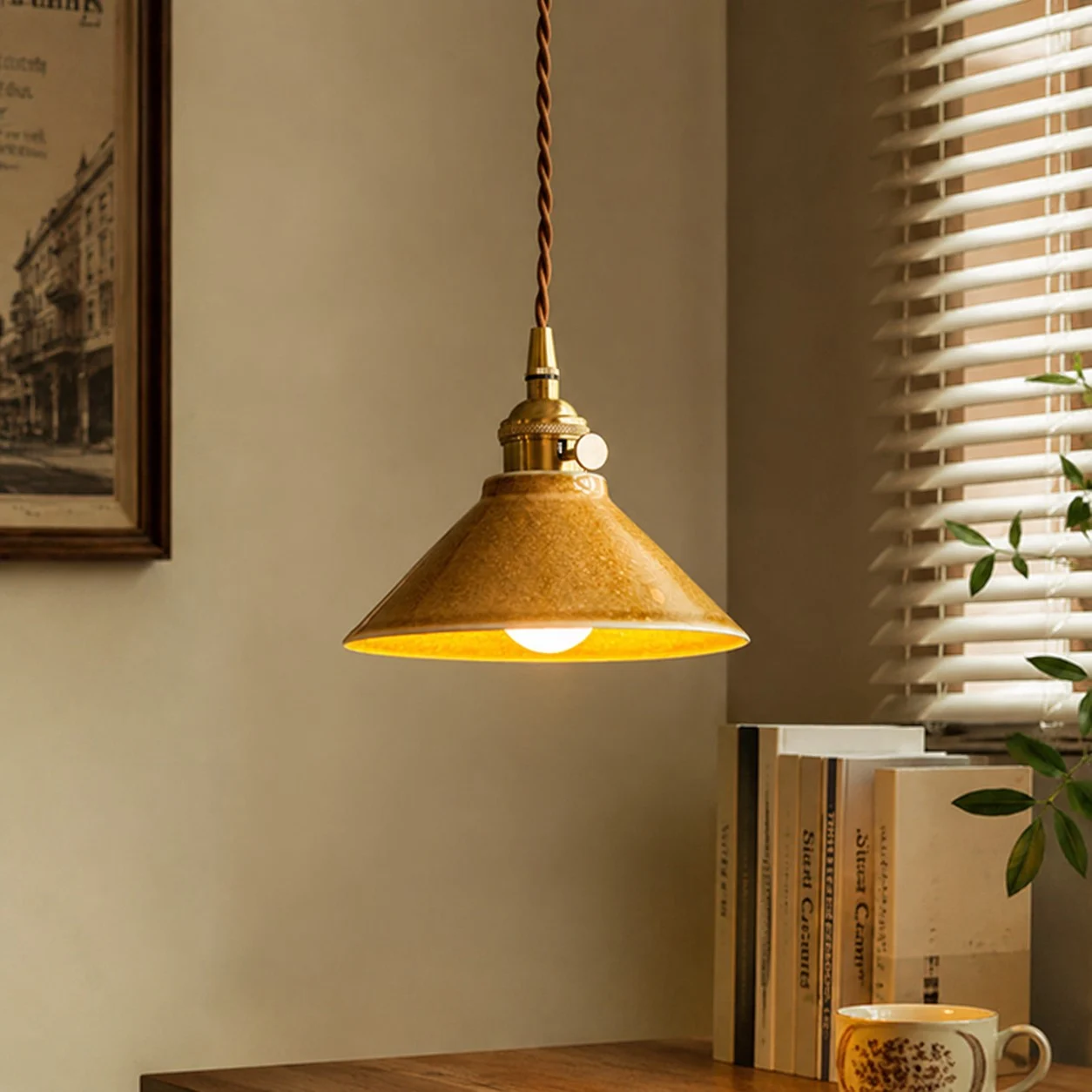 Yellow ceramic pendant light by a warm window corner