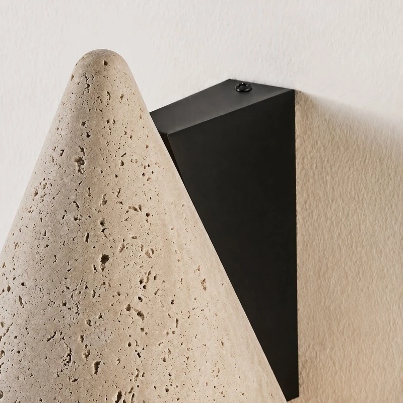 Black wall plate and travertine cone side detail