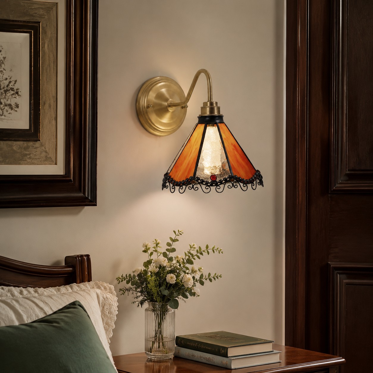 Orange stained glass wall sconce beside a vanity mirror