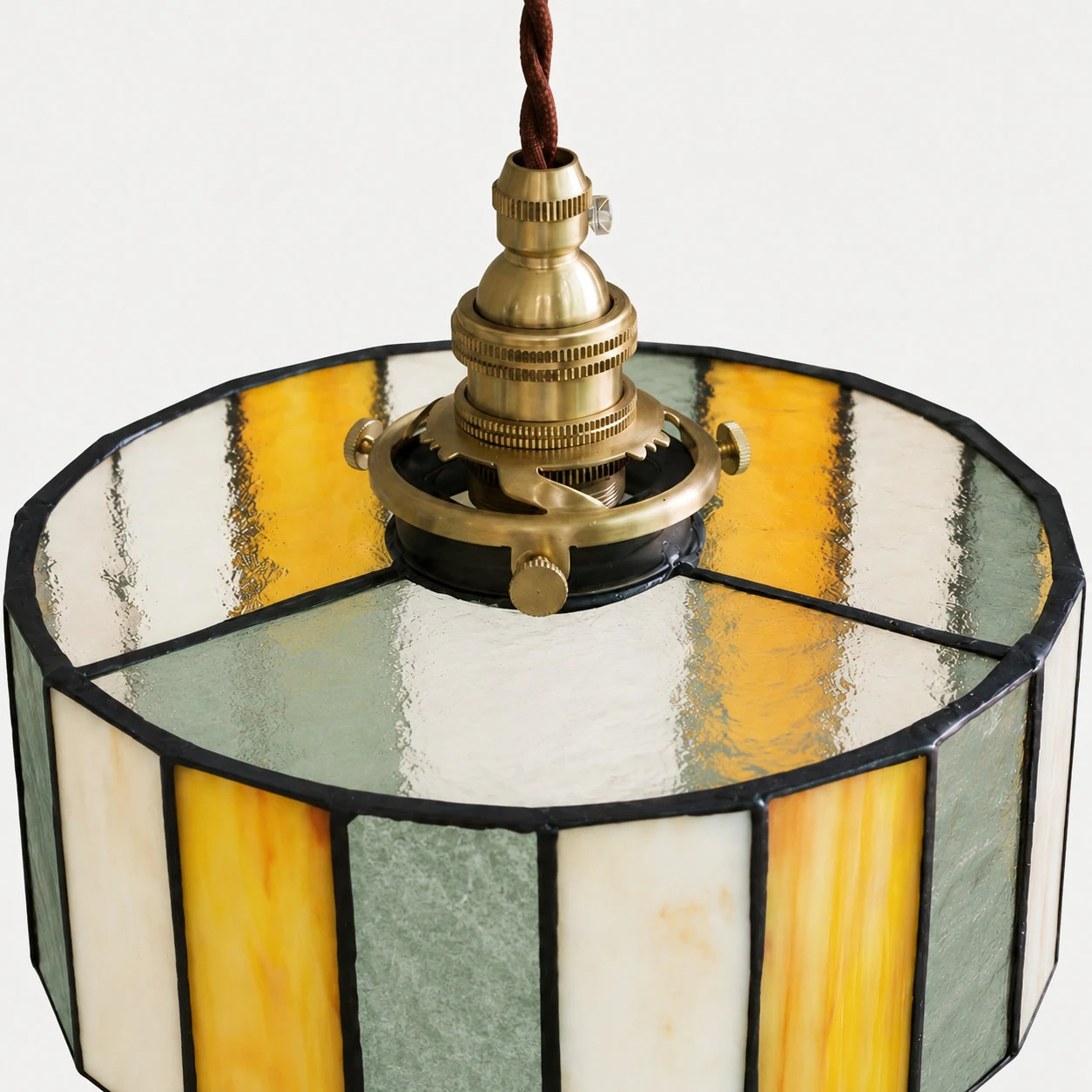 Close view of brass socket hardware and textured glass shade