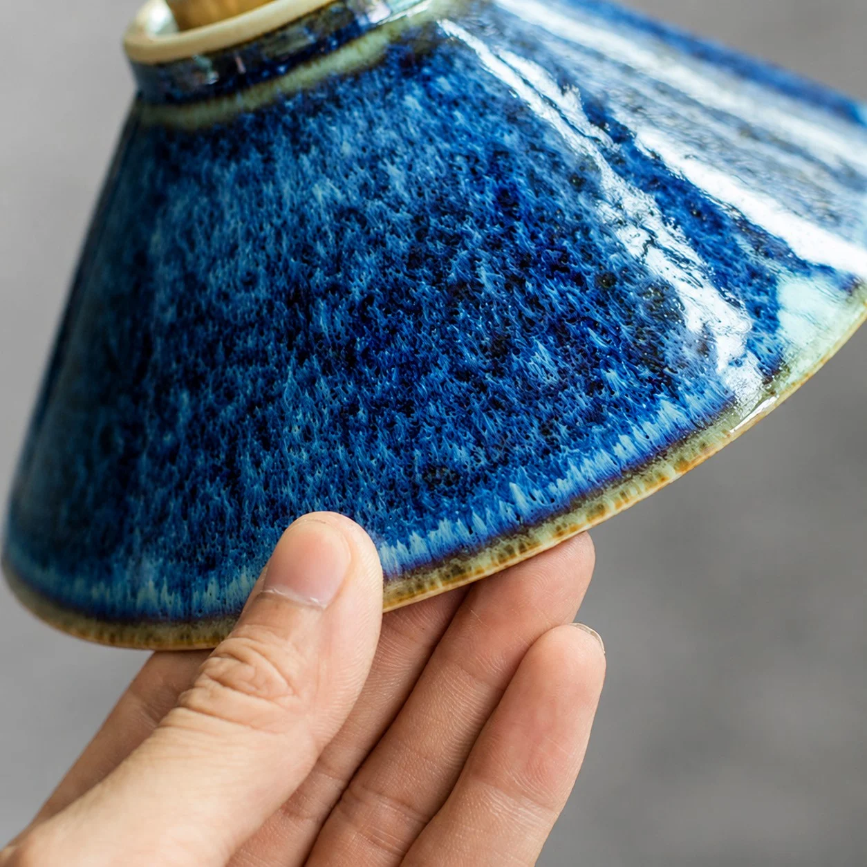 Handheld close view of the blue ceramic shade edge texture