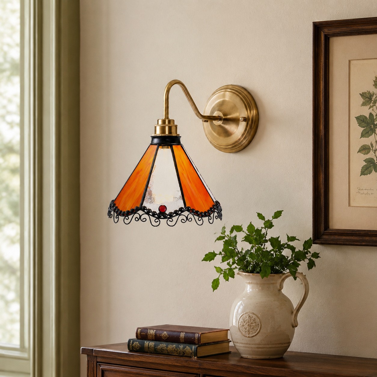 Orange stained glass wall sconce on a framed art wall