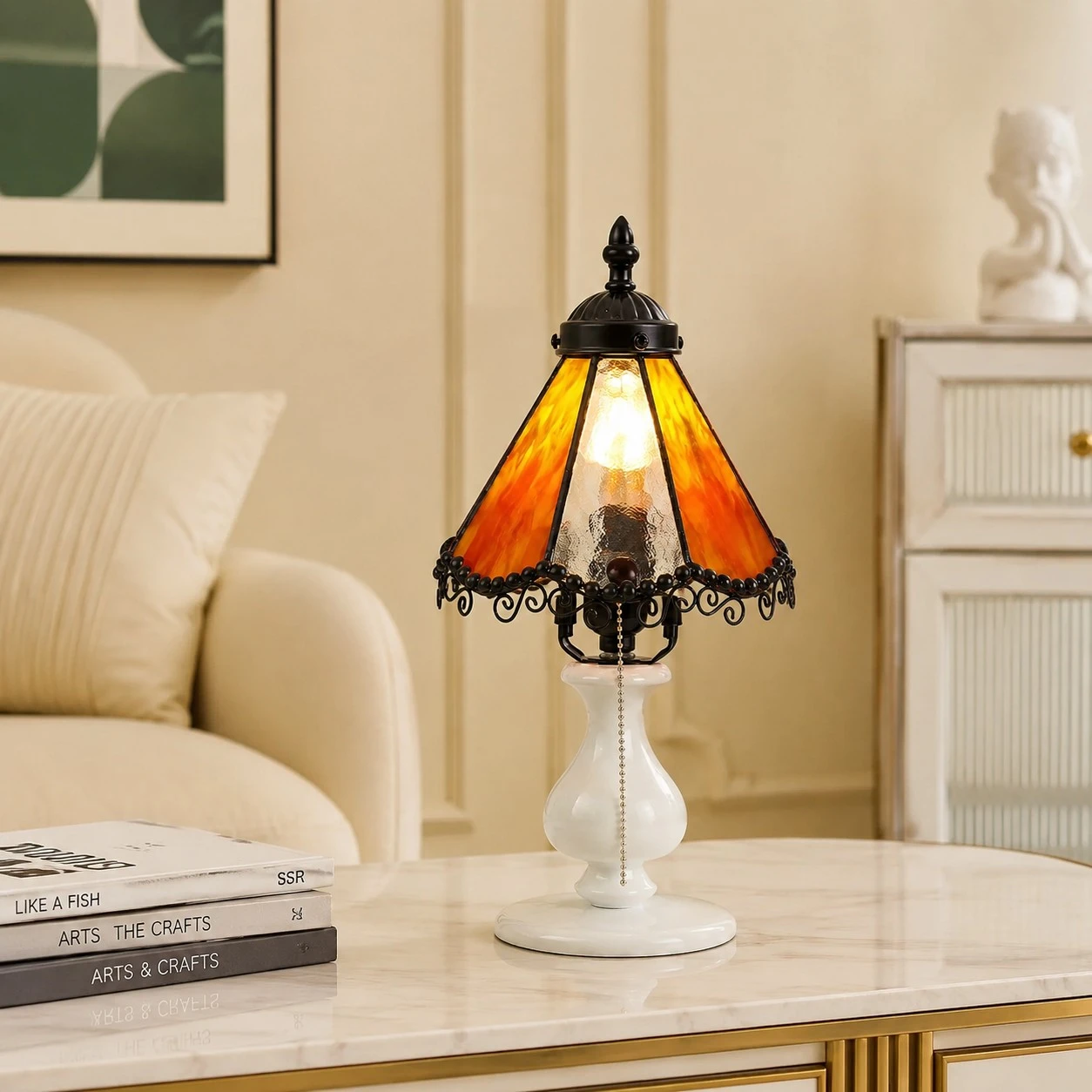 Orange stained glass table lamp styled on a bedside table in a cream bedroom