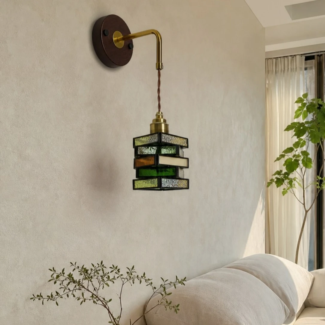 Colorful glass wall sconce above a sofa