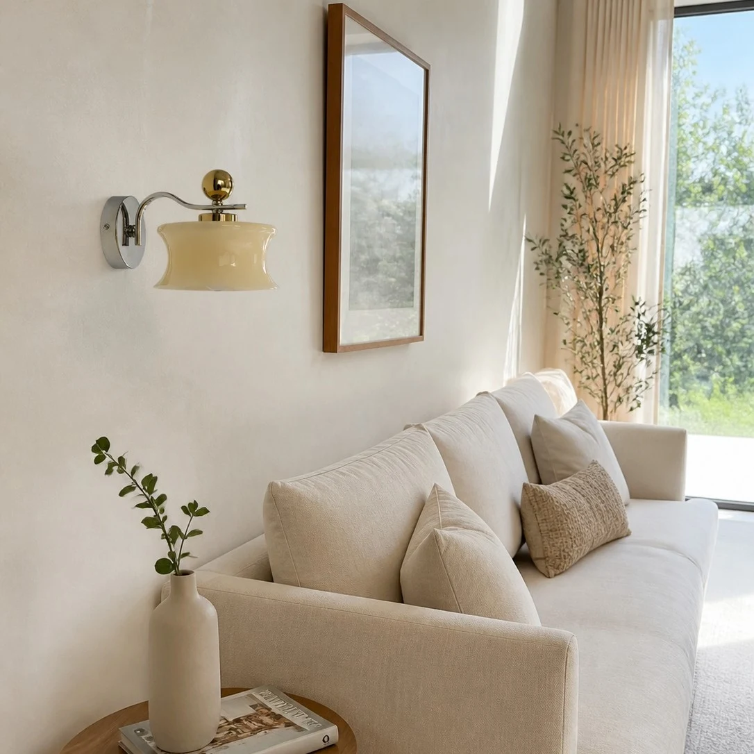 Cream glass wall lamp above a sofa