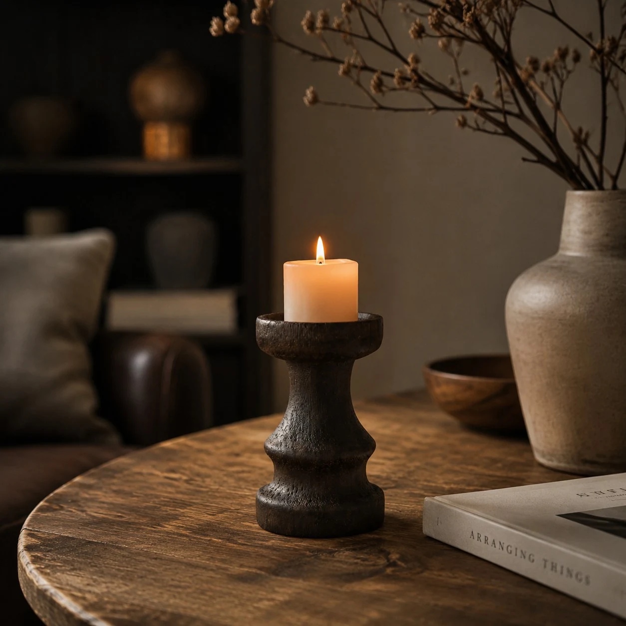 Solid wood candle holder in a dark neutral tabletop scene; candle not included