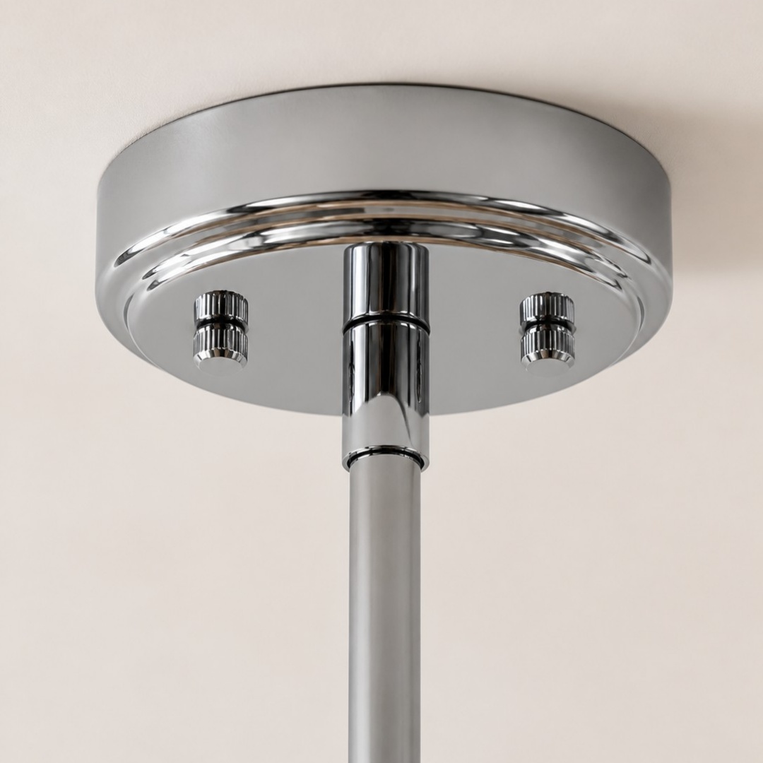 Close view of the polished metal ceiling canopy and downrod