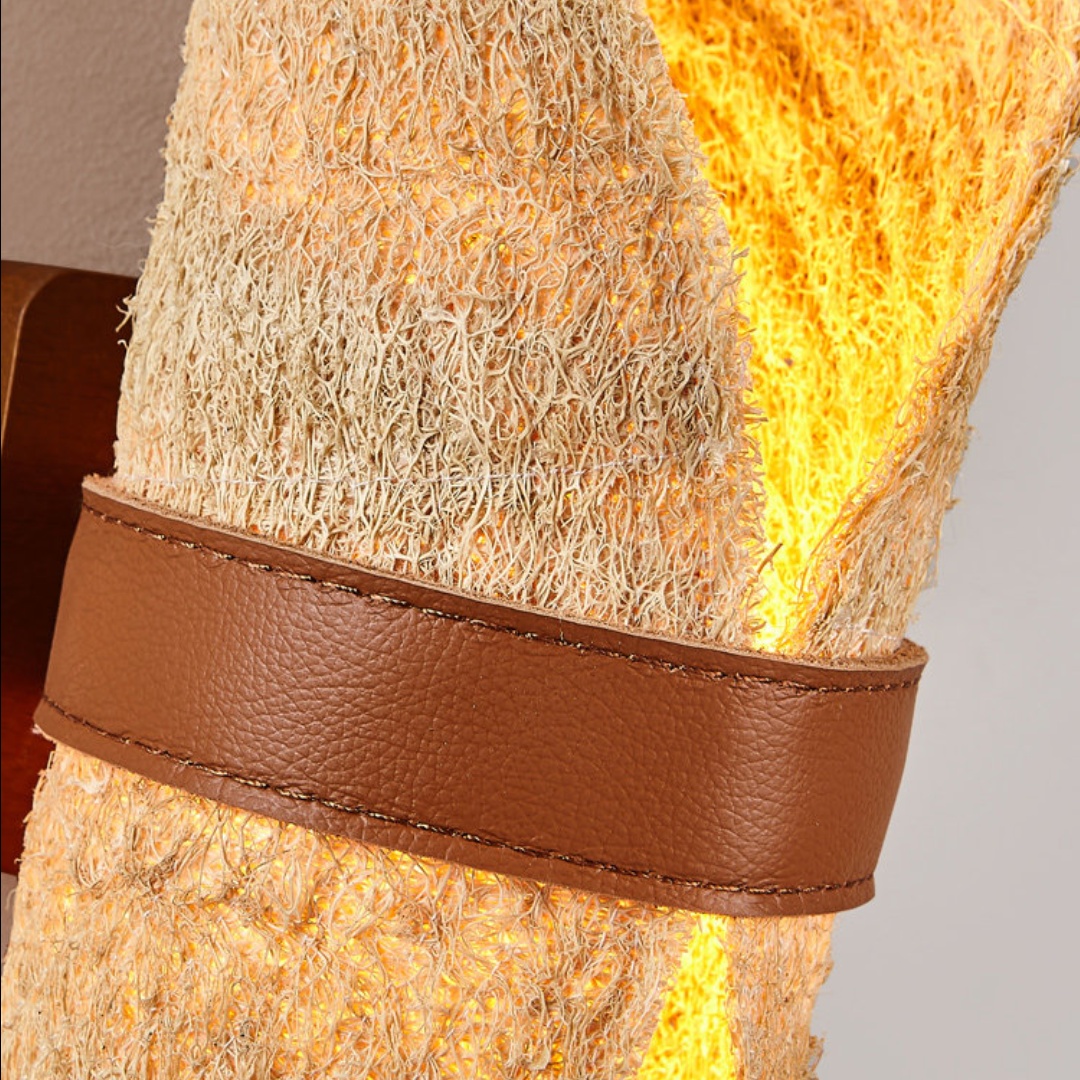 Close view of the stitched brown leather band and loofah fibers