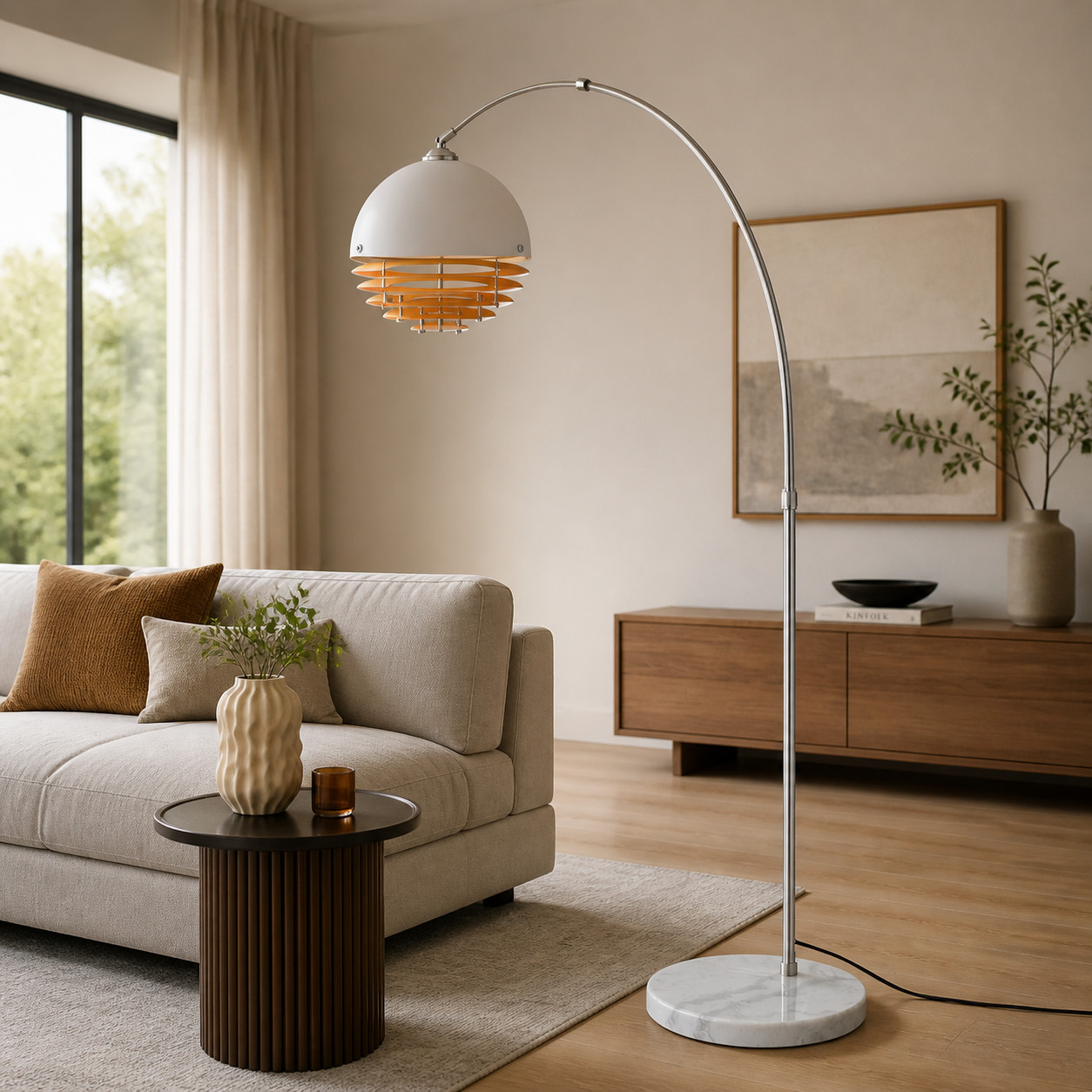 Chrome arc floor lamp beside a sofa