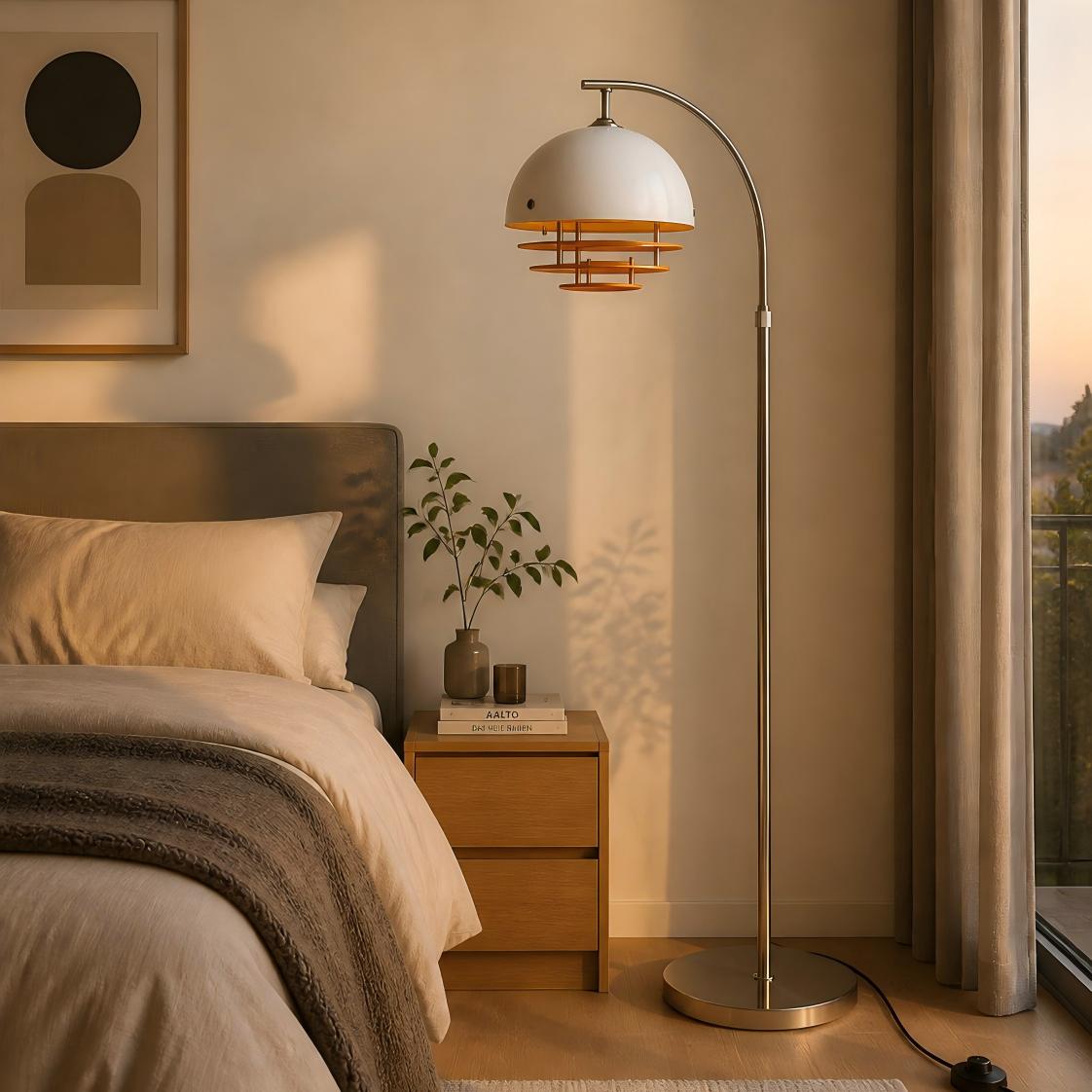 White-orange glass arc floor lamp beside a bed