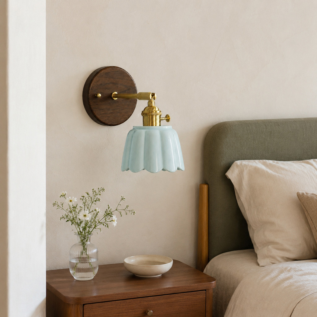 Ceramic wall sconce styled beside a warm bedside wall