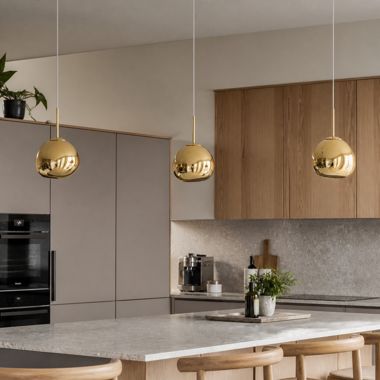 Gold pendant lights above a kitchen island