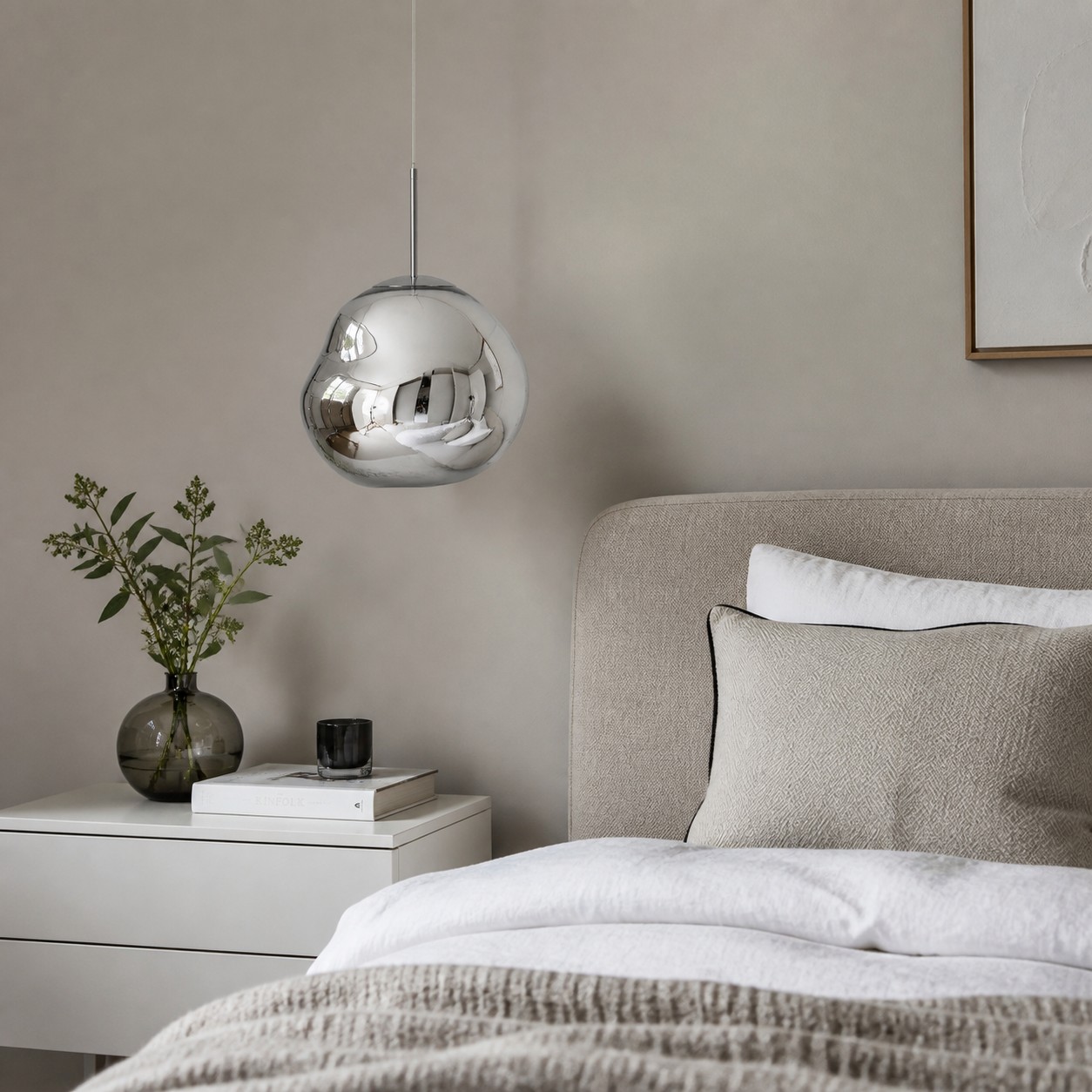 Silver pendant beside a bed