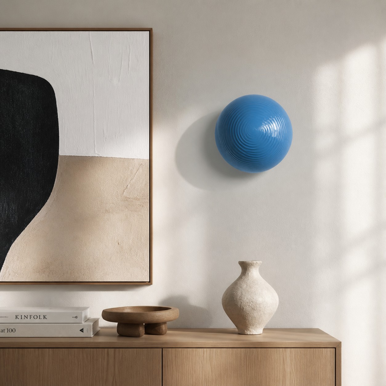 Blue glass lollipop wall light beside modern wall art