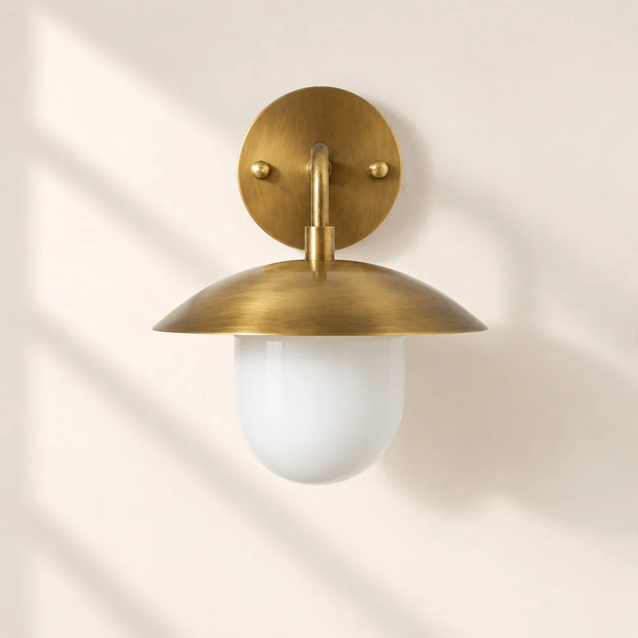 Brass-Finish Wall Sconce: Frosted White Glass Globe &mdash; A clear perspective