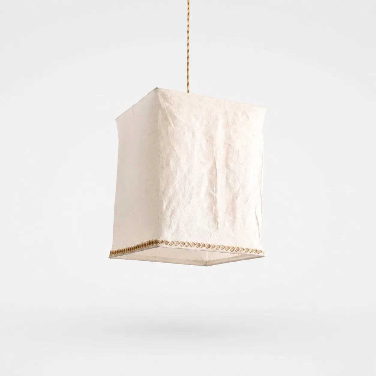 Sculptural linen pendant light on a clean light background
