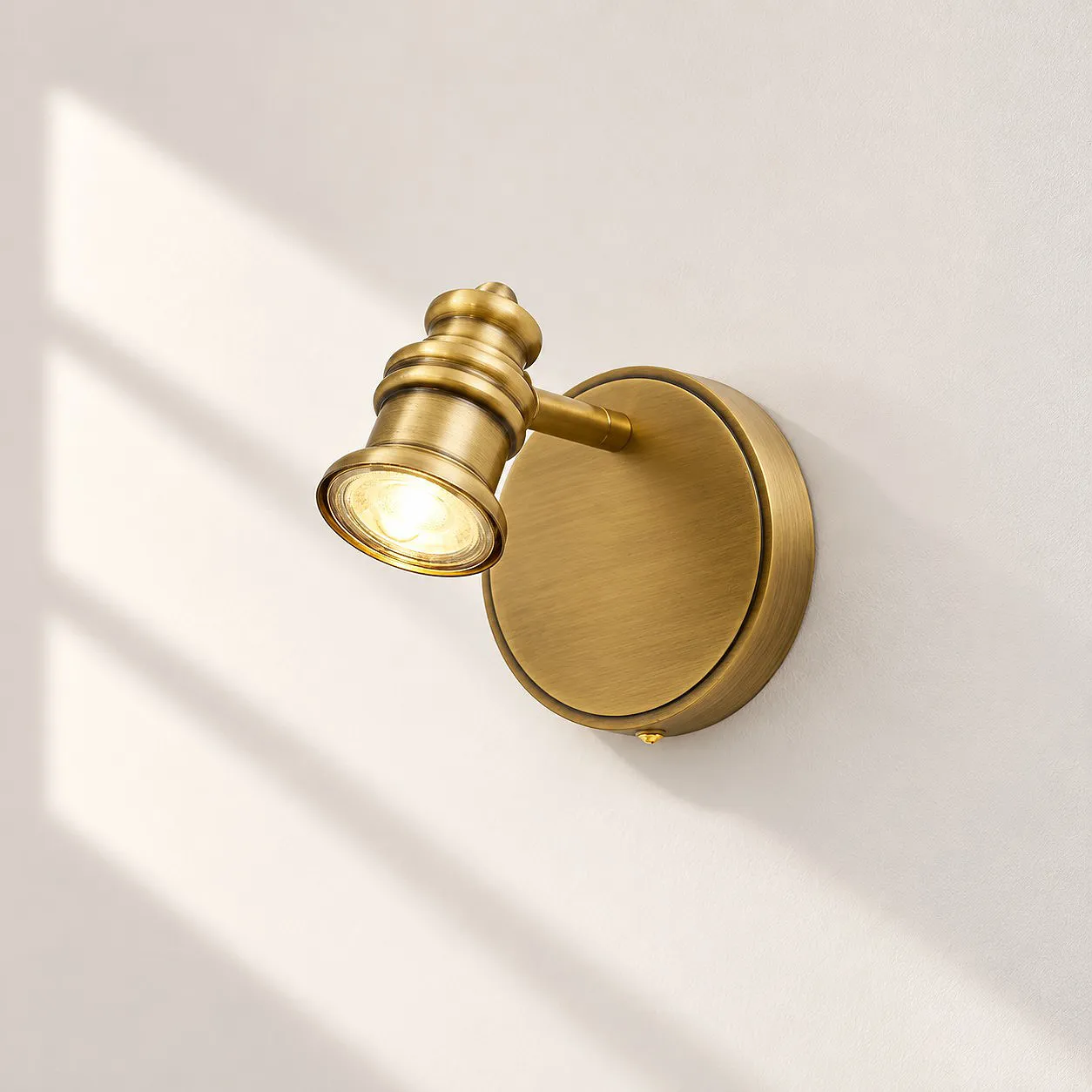 Sculpted Heads &mdash; Aurelia Adjustable Natural Brass Wall Light &mdash; A clear perspective